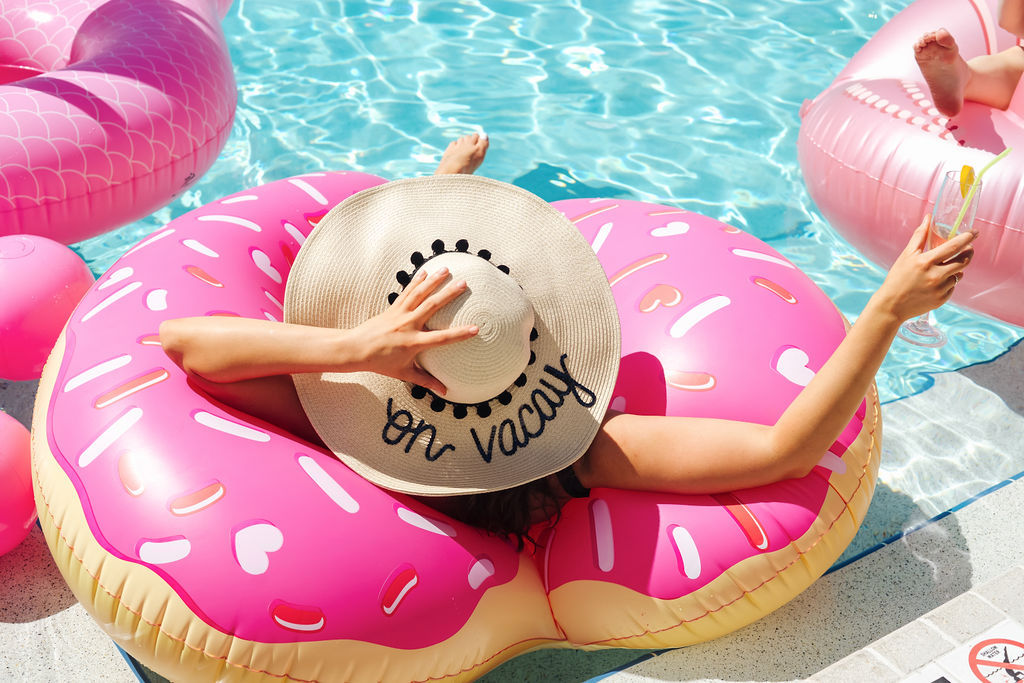 Tampa Bay Bachelorette Party, Bridesmaid on Big Donut Pool Float in Personalized Hat | Tampa Bay Wedding Venue The Godfrey Hotel | Photographer Grind and Press Photography