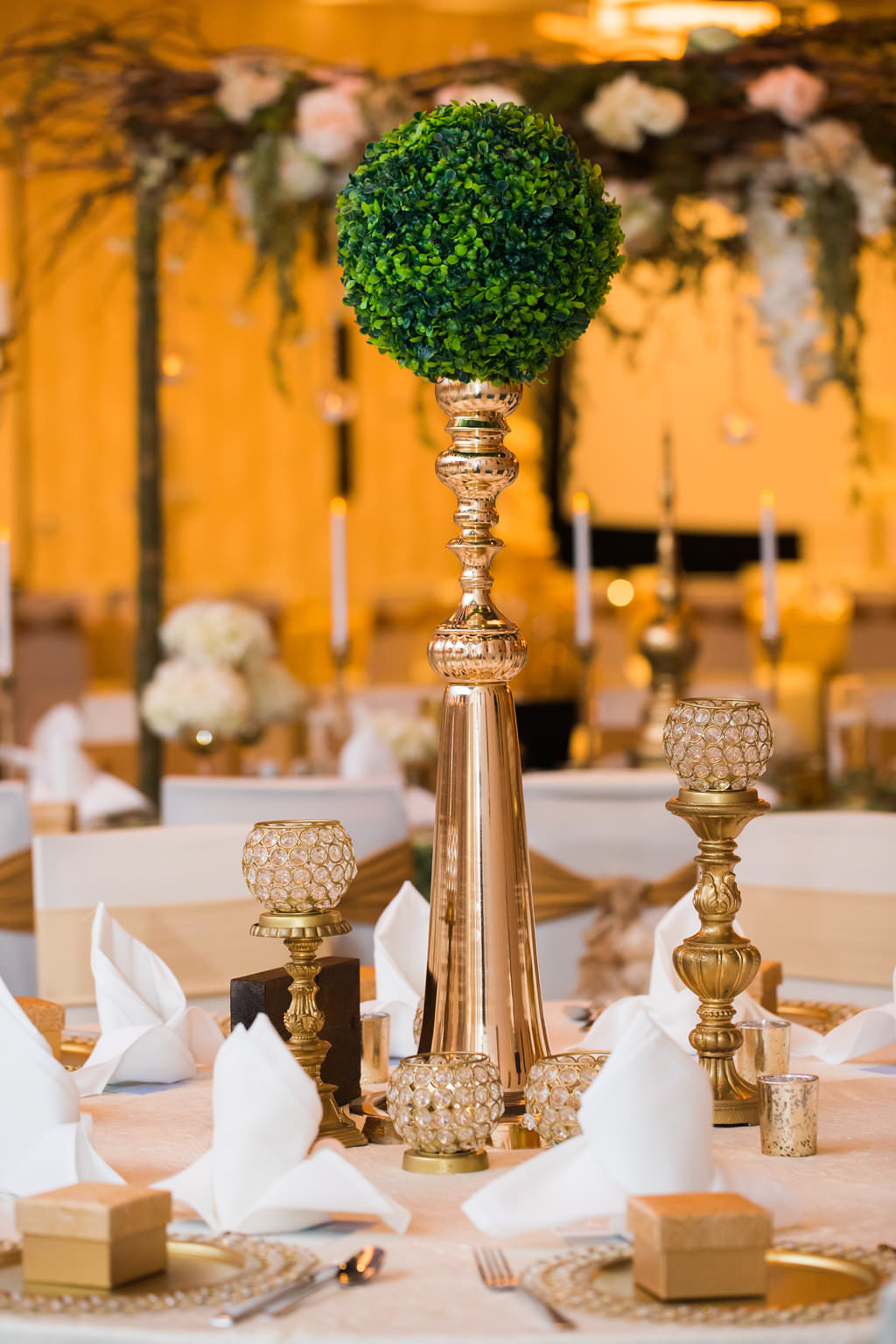 Glamorous Traditional Indian Wedding Hotel Ballroom Reception Decor, Tall Gold Vase with Round Greenery Plant, Gold Candlesticks, Gold Chargers and Party Favor Boxes