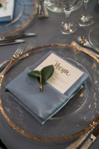 Elegant, Modern Wedding Reception Decor, Clear and Gold Rimmed Charger, Dusty Blue Linen, Gold Foil Menu and Green Leaf | Tampa Bay Photographer Cat Pennenga Photography | Sarasota Wedding Planner NK Productions