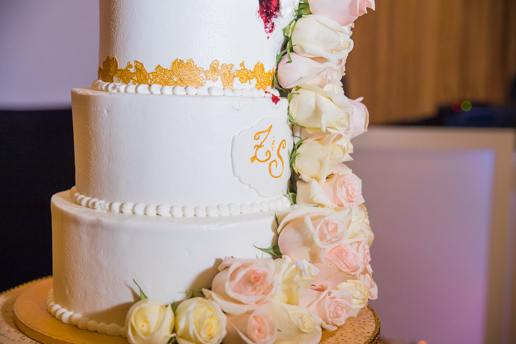 Three Tier White Wedding Cake with Gold Decoration and Initials with Cascading Blush Pink and Ivory Roses