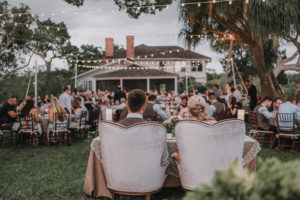Creative Outdoor Garden Style Wedding Reception Portrait of Bride and Groom at Sweetheart Table | Sarasota Wedding Venue Historic Spanish Point