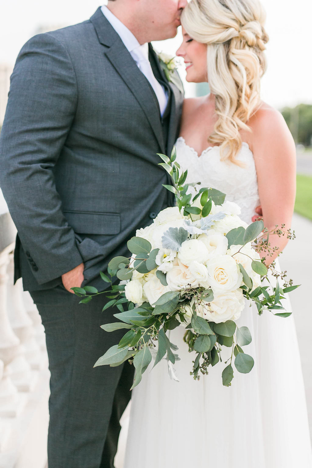 Bride and Groom Outdoor Wedding Portrait, Bride in Strapless Sweetheart A-Line Lace Wedding Dress with White and Greenery Floral Bouquet, Groom in Grey Tuxedo | Tampa Bay Hair and Makeup Femme Akoi