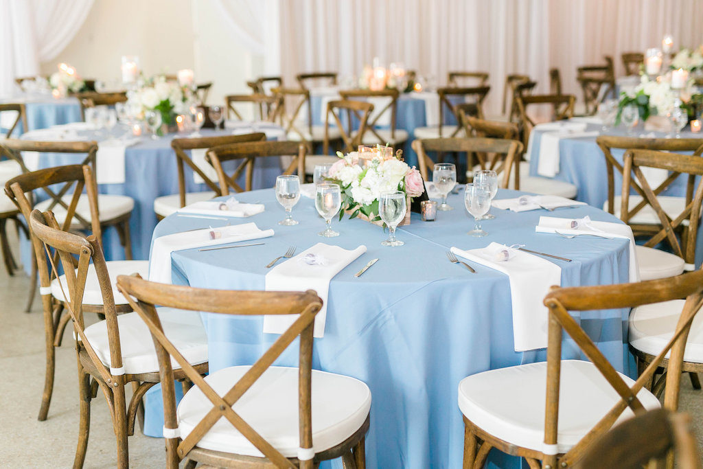 Wedding Reception Decor, Round Tables with Blue Tablecloths, Wooden Chiavari Chairs and White Linen Cushions, White, Blush Pink and Greenery Low Floral Centerpiece | Tampa Bay Wedding Rentals A Chair Affair