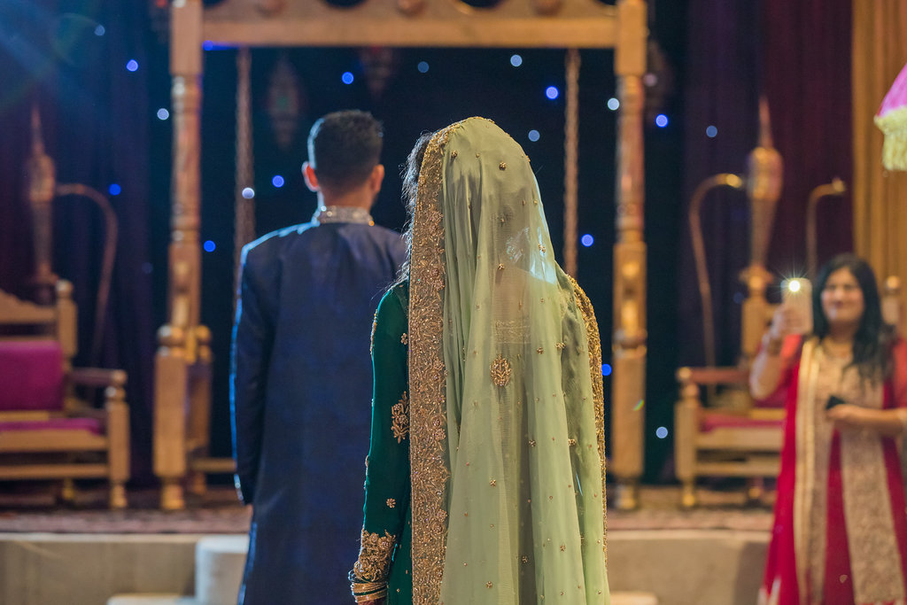 Glamorous Tampa Bay Indian Wedding Bride and Groom First Look Portrait, Bride in Traditional Green and Gold Saree