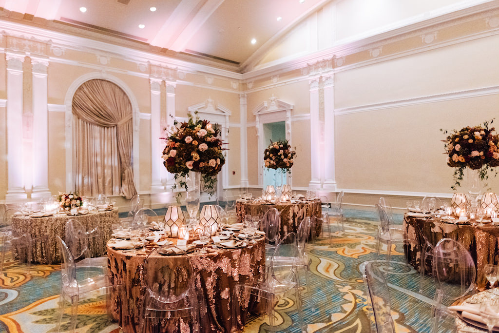Elegant, Romantic Hotel Wedding Reception Decor, Round Tables with Gold Sequin Tablecloths, Clear Acrylic Chairs, Tall Clear Vase with Burgundy, Dusty Rose and Greenery Floral Centerpieces, White and Gold Geometric Candle Vases | Tampa Bay Wedding Planner Parties A'la Carte | St. Petersburg Hotel Wedding Venue The Vinoy Renaissance
