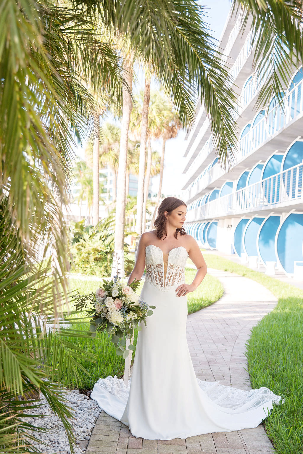Bride Outdoor Portrait in Strapless Deep V-Neck Illusion and Lace wedding Dress with Organic Greenery, Blush Pink, Ivory, and Blue Wedding Floral Bouquet | Tampa Wedding Photographer Kristen Marie Photography | Tampa Wedding Dress Shop Truly Forever Bridal | Hair and Makeup Michele Renee the Studio
