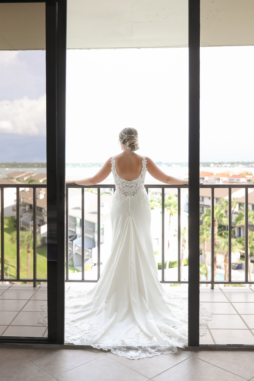 Florida Bride on Balcony of Hotel in Scoop Back Lace Fitted Wedding Dress | Tampa Bay Wedding Photographer Lifelong Photography Studios | Clearwater Beach Hotel Wedding Venue Hilton Clearwater Beach