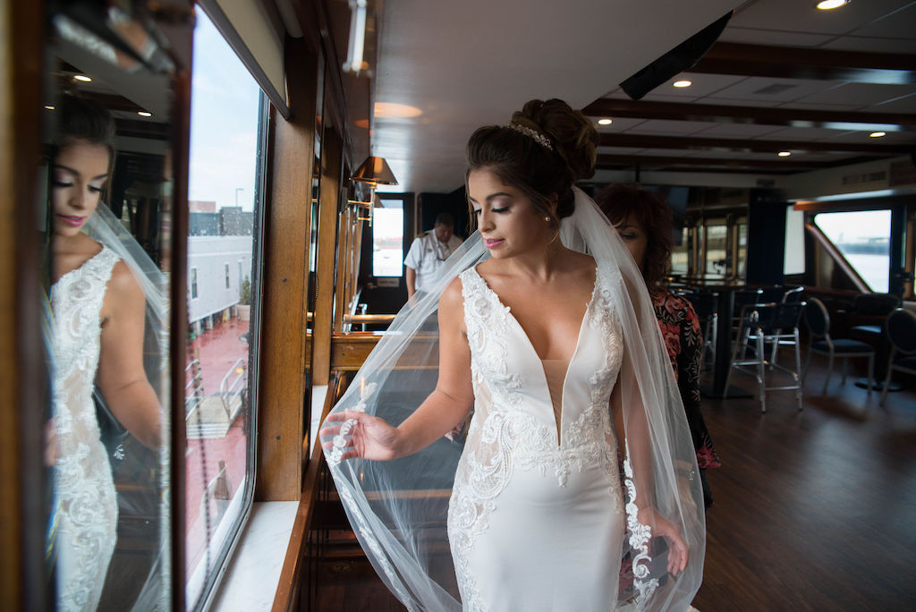 Florida Bride Portrait on Tampa Waterfront Wedding Venue Yacht Starship II in Deep V Neck Illusion Lace and Fitted Tank Top Strap Wedding Dress with Veil | Tampa Bay Wedding Photographer Kristen Marie Photography | Hair and Makeup Destiny & Light Hair and Makeup Group | Wedding Dress Nikki's Glitz and Glam Boutique