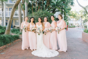 Outdoor Florida Bride and Bridesmaids Wedding Portrait in V Neck Lace Fitted and Spaghetti Strap Wedding Dress with White Hydrangeas, Blush Pink and Succulent Floral Bouquet, Bridesmaids in Matching Long Blush Pink Dresses | Tampa Bay Photographer Kera Photography | Hair and Makeup Michele Renee the Studio