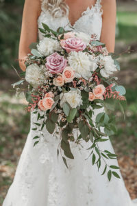Bride Wedding Portrait with Organic Wild Floral Bouquet with Blush Pink and Dusty Pink Roses, White Flowers, and Greenery, Bride in Floral Lace Embellished Fit and Flare V Neck Wedding Dress with Straps | Tampa Bay Wedding Dress Shop Truly Forever Bridal