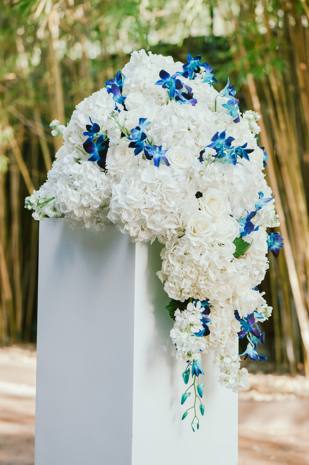 Outdoor Wedding Ceremony Decor, White Hydrangeas and Blue Orchids on White Pedestal Floral Arrangement