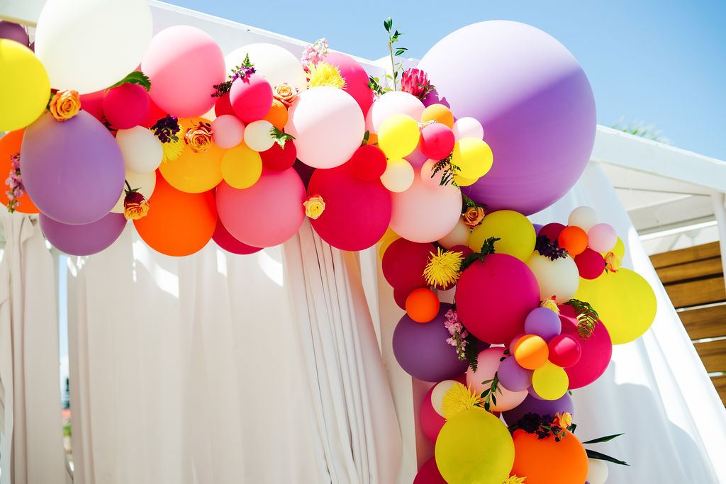 Colorful Purple, Pink, Red, Yellow, White and Hot Pink Balloon Arch with Real Florals and White Linen Backdrop | Tampa Bay Photographer Grind and Press Photography