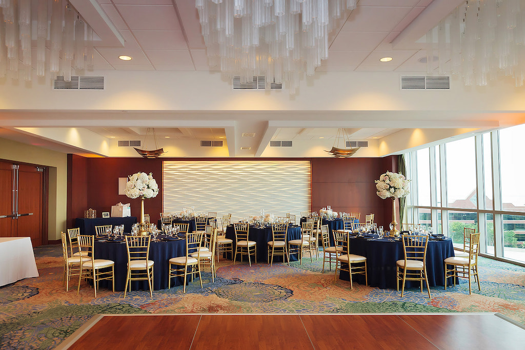Ballroom Wedding Reception Decor, Round Tables with Navy Blue Tablecloths, Gold Chiavari Chairs, Tall Gold Vase with Ivory Floral Centerpieces |Tampa Bay Wedding Venue The Westin Tampa Bay