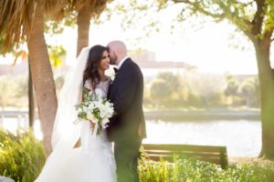 Outdoor Florida Bride and Groom Downtown Tampa Wedding Portrait, Bride in Mermaid Silhouette, Illusion Cap Sleeve Rhinestone, Pearl, Lace and Tulle Wedding Dress with White and Greenery Floral Bouquet | Tampa Bay Wedding Photographer Andi Diamond Photography
