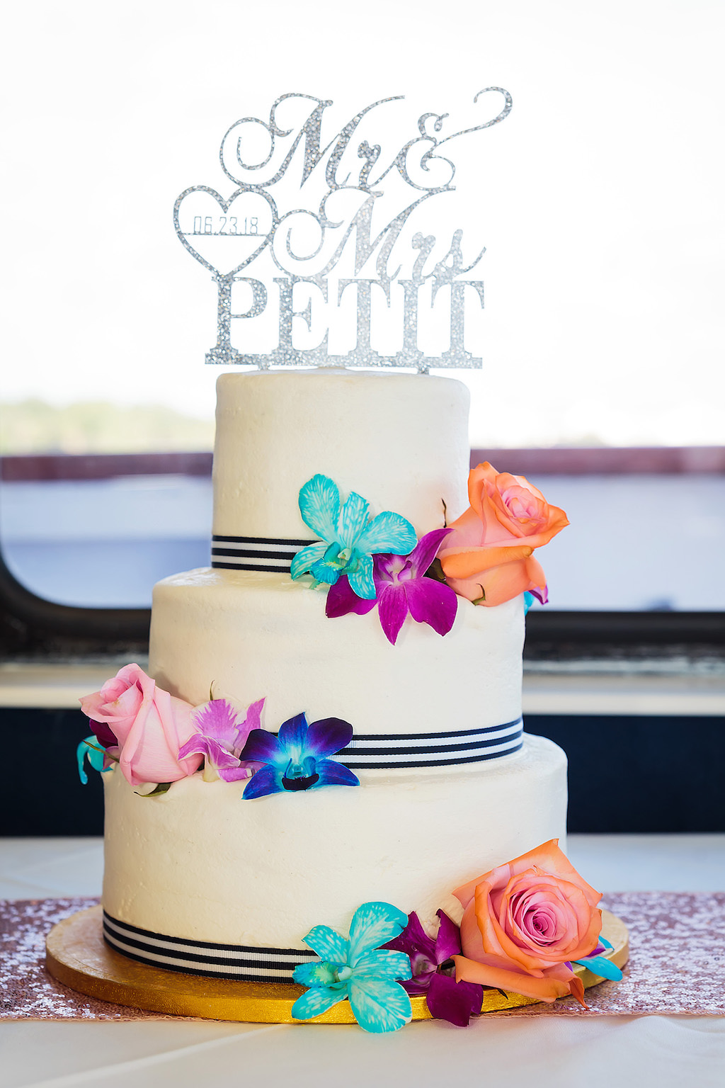 Three Tier White with Navy Blue Accent and Colorful Tropical Real Flowers and Glitter Silver Lasercut Personalized Cake Topper