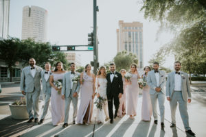 Outdoor Downtown Tampa Bride, Groom and Bridal Party Wedding Portrait, Bridesmaids in Lavender Dresses, Groomsmen in Grey Tuxedos, Bride in Lace and Illusion Scoop Neckline Long Sleeve Wedding Dress, Groom in Black Tuxedo | Tampa Bay Wedding Photographer Brandi Image Photography