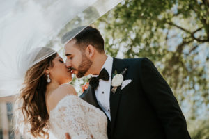 Creative Outdoor Florida Bride and Groom Wedding Portrait with Veil | Tampa Bay Wedding Photographer Brandi Image Photography