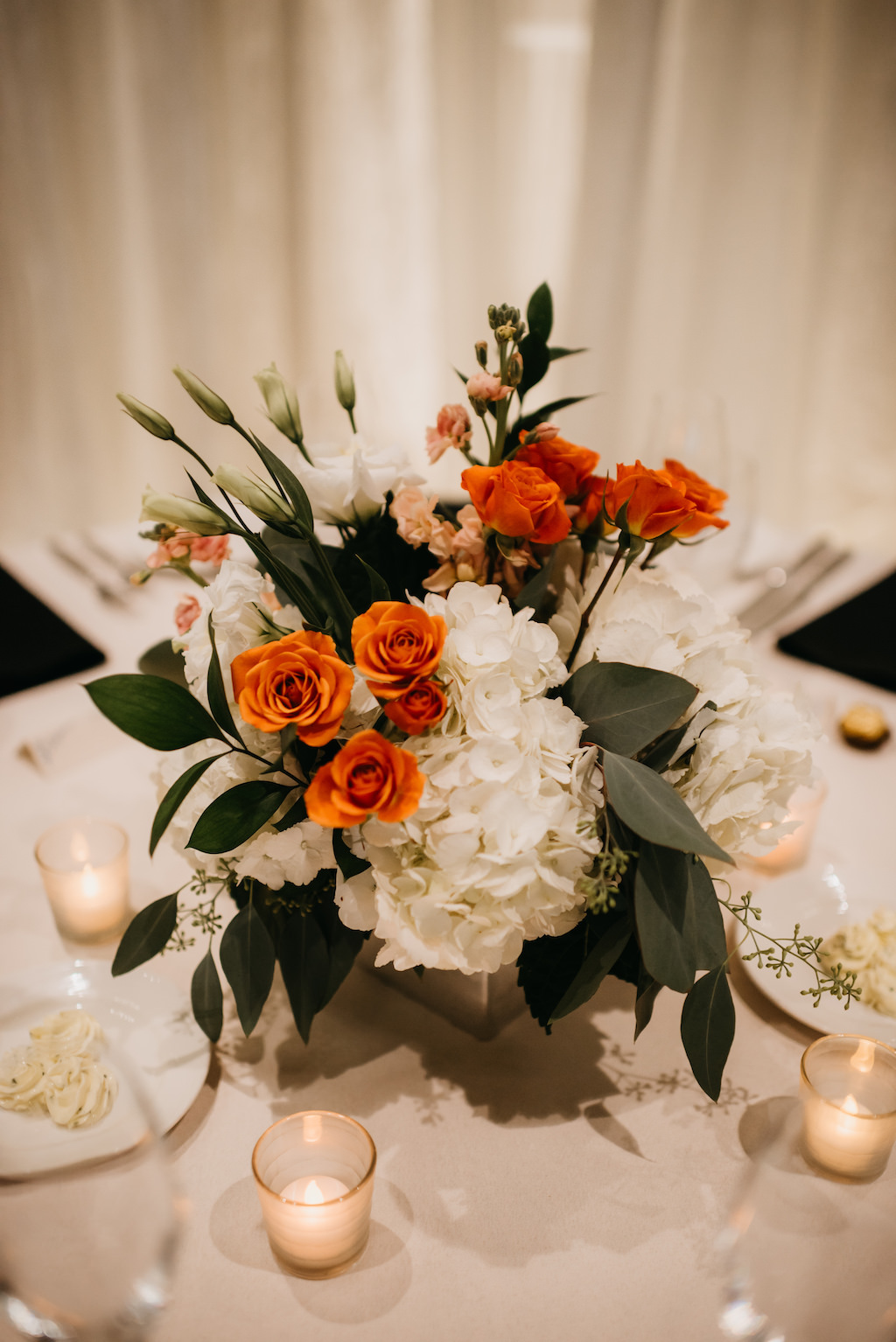 Old Florida Inspired Wedding Reception Decor, White Hydrangeas, Orange and Greenery Floral Centerpiece, Votive Candles
