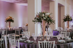 Modern Wedding Reception Decor with Silver Chiavari Chairs and Round Tables with Purple Linens, Tall Gold Vases and Blush Pink, Greenery, and White Floral Centerpiece | Downtown Tampa Wedding Venue The Vault | Tampa Bay Wedding Photographer Brandi Image Photography
