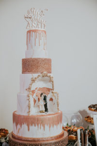 Six Tier White and Rose Gold Wedding Cake with Marble Effect, Rose Gold Drip Top Tier, Middle Tier Cutout with World Map Design in Rose Gold and Bride and Groom Figurines, Laser Cut Personalized Cake Topper | Tampa Bay Wedding Photographer Brandi Image Photography | Tampa Wedding Cakes The Artistic Whisk