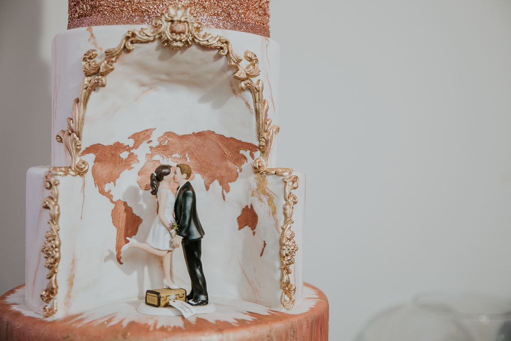 Elegant, Unique White and Rose Gold Wedding Cake with Cutout Designed with Rose Gold World Map and Vintage Gold Decorative Outlining, Bride and Groom Figurines | Tampa Bay Wedding Photographer Brandi Image Photography | Tampa Wedding Cakes The Artistic Whisk