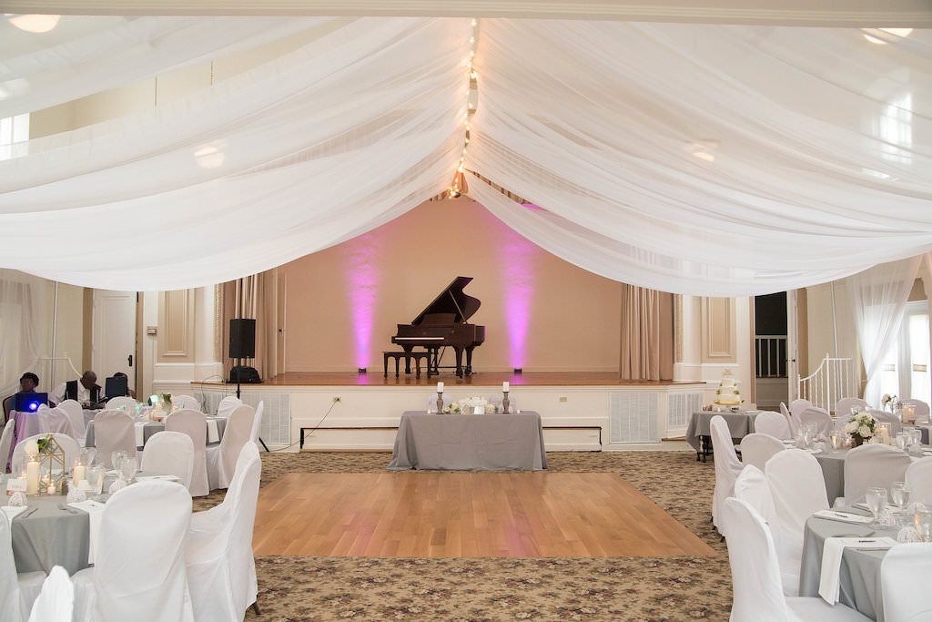 Modern Wedding Reception, White Draping, Pink Uplighting, Black Grand Piano, Sweetheart Table with Grey Tablecloth, Chairs with White Chair Covers | Tampa Bay Wedding Photographer Kristen Marie Photography | Wedding Venue St. Petersburg Woman's Club