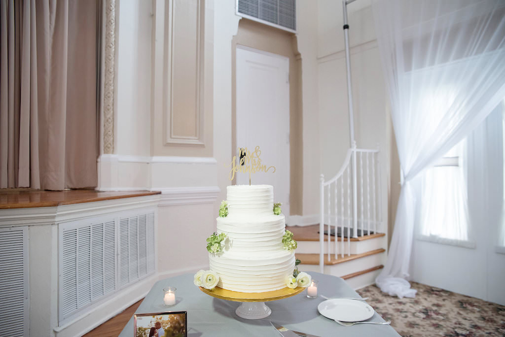 Three Tier White Ruffle Wedding Cake with Green and White Flowers and Gold Laser Cut Cake Topper | Tampa Bay Wedding Photographer Kristen Marie Photography | Wedding Venue St. Petersburg Woman's Club