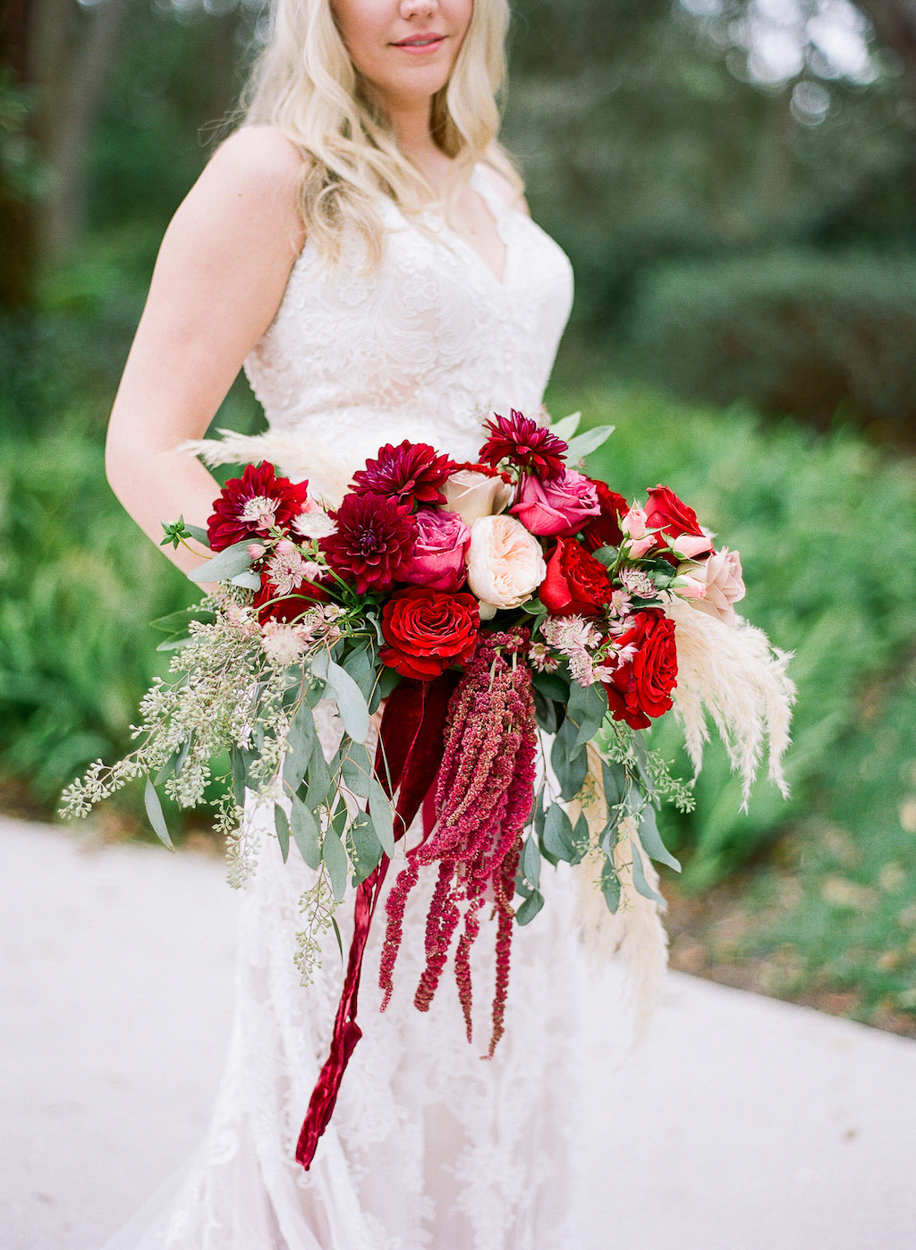 Florida Bride Wedding Portrait in Fitted Lace Wedding Dress with Tank Top Straps and Red, Pink, Ivory and Greenery Floral Bouquet | Tampa Bay Bridal Shop Nikki's Glitz and Glam Bridal Boutique