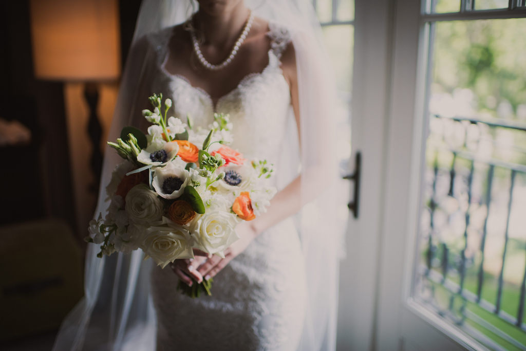 Florida Bride Wedding Portrait Lace, V Neckline with Lace Strap Essense of Australia Wedding Dress and White Rose, Coral, and White Anemone Floral Bouquet