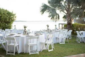 Outdoor Waterfront Florida Wedding Reception Decor, Round Tables with White Tablecloths, White Wooden Folding Chairs | Waterfront St. Pete Wedding Venue Tampa Bay Watch