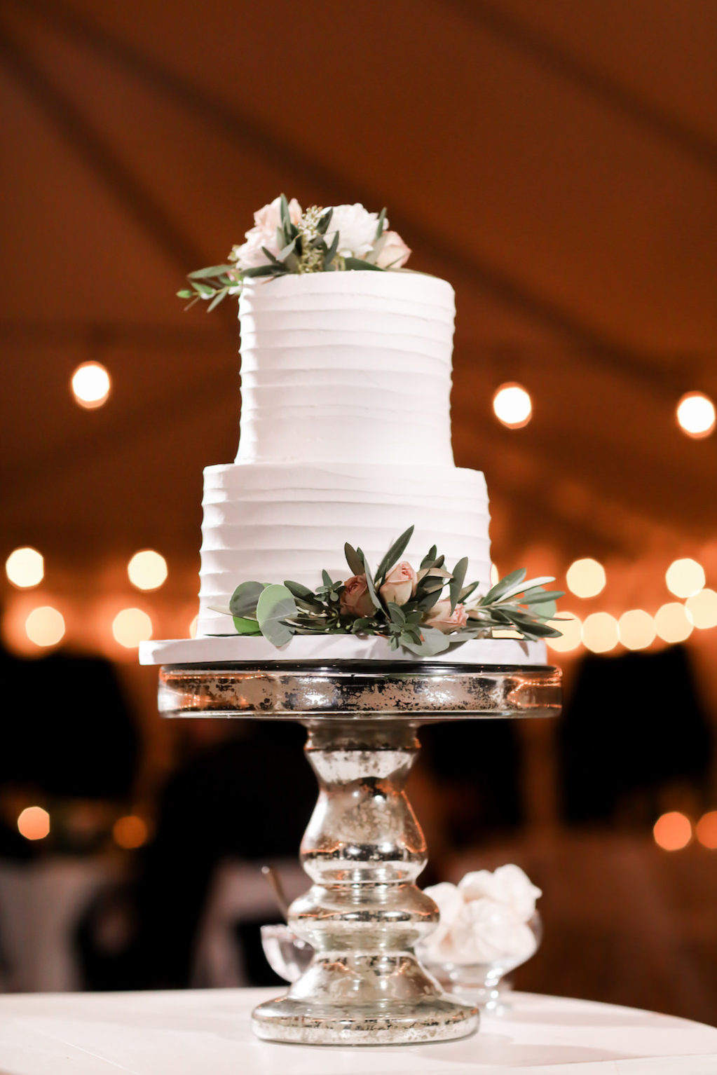 Simple Two Tier White Wedding Cake with Real Ivory, Greenery and Blush Pink Roses on Silver Mercury Cake Stand | Tampa Bay Wedding Photographer Lifelong Photography Studio | Wedding Planner Love Lee Lane | Wedding Cake Alessi Bakeries