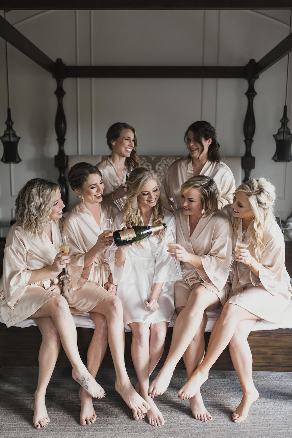 Florida Bride and Bridesmaids Getting Ready Wedding Portrait Drinking Champagne in Silk Beige Robes | Tampa Bay Wedding Hair and Makeup Artist Michele Renee the Studio