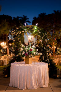 Nighttime Wedding Outdoor Garden Courtyard Wedding Reception Decor, Round Table with Glitter Blush Pink Linen, Gold Vase with Whimsical Organic Garden Greenery, Ivory, White, Red Floral Centerpiece | Sarasota Wedding Venue Ringling Museum | Tampa Bay Wedding Planner NK Weddings