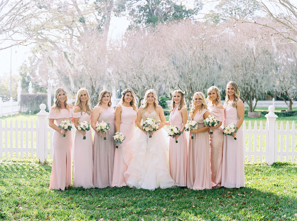 Florida Bride and Bridesmaids Outdoor Wedding Portrait, Bridesmaids in Mismatched Long Blush Pink Dresses, Bride in Watters Nude Rhinestone Embellished Spaghetti Strap Bodice and Tulle Flowy Skirt Ballgown Wedding Dress with Ivory Garden Roses and Silver Dollar Eucalyptus Greenery Floral Bouquet | Sarasota Wedding Venue Palmetto Riverside Bed and Breakfast | Tampa Bay Wedding Florist Cotton & Magnolia
