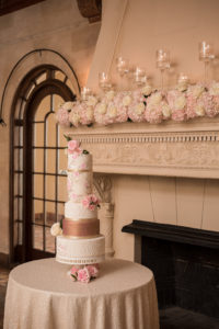 Wedding Reception Decor, Blush Pink and White Floral Arrangements on Fireplace with Floating Candles, Tall Four Tier White, Rose Gold, and Floral Wedding Cake | Tampa Bay Wedding Photographer Cat Pennenga Photography | Wedding Planner NK Productions | Sarasota Wedding Venue Powel Crosley Estate