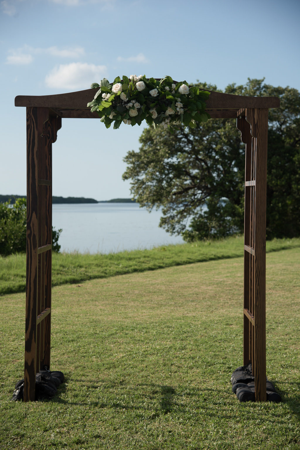 Outdoor Wedding Ceremony Decor, Wooden Arch with Greenery and White Floral Bouquet | Tampa Bay Wedding Florist Cotton and Magnolia