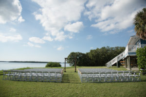 Outdoor Florida Wedding Ceremony Decor, White Wooden Folding Chairs, Wooden Ceremony Arch | St. Pete Waterfront Wedding Venue Tampa Bay Watch
