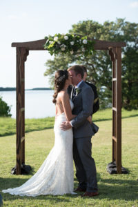 Florida Bride and Groom Outdoor Wedding Ceremony Portrait, Wooden Arch with Greenery and White Floral Bouquet | Tampa Bay Wedding Florist Cotton and Magnolia