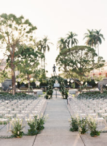Elegant Modern Garden Courtyard Ceremony Decor, Ghost Chairs, Greenery and White Floral Ceremony Arch | Sarasota Wedding Venue Ringling Museum | Tampa Bay Wedding Planner NK Weddings