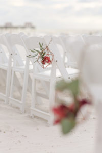 Florida Beach Wedding Ceremony Decor, White Folding Chairs with Geometric Vase and Red and Green Floral Inside | Tampa Bay Wedding Photographer Lifelong Photography Studios | Clearwater Beach Hotel Wedding Venue Hilton Clearwater Beach