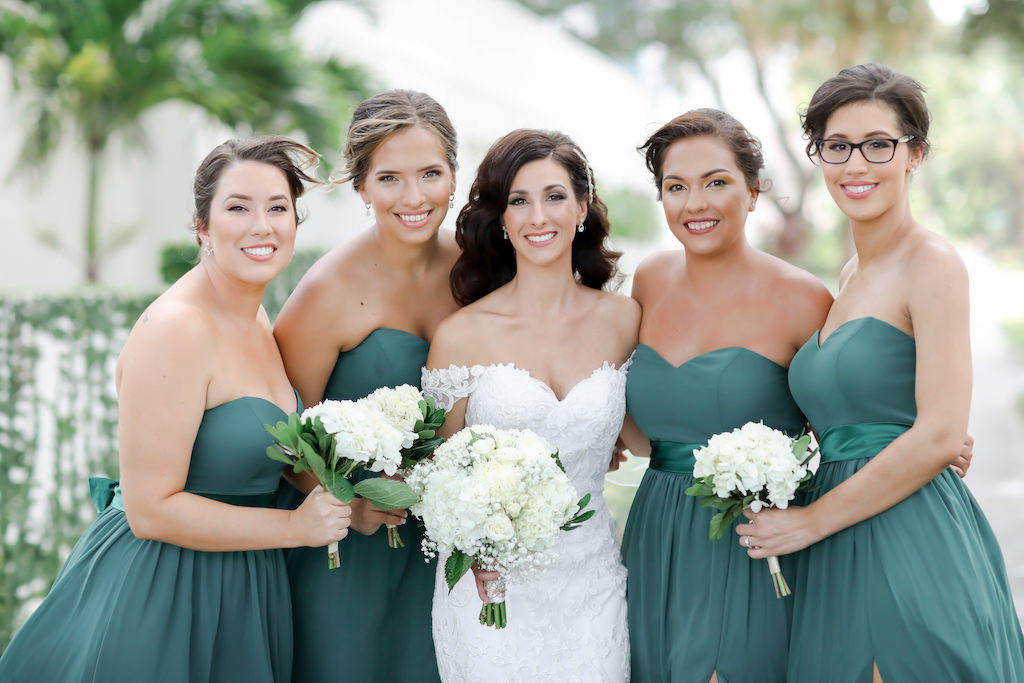 St. Pete Bride and Bridesmaids Outdoor Wedding Portrait, Bridesmaids in Green Long Matching Dresses, Bride in Lace Fitted Sweetheart Neckline Off the Shoulder Wedding Dress with White and Ivory Round Classic Floral Bouquet | Tampa Bay Wedding Photographer Lifelong Photography Studio | Hair and Makeup Artist Destiny and Light