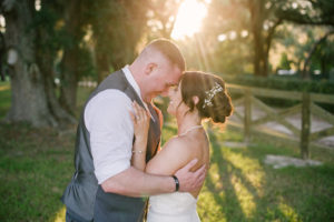 Florida Bride and Groom Outdoor Sunset Wedding Portrait | Florida Rustic Wedding Venue Lakeside Ranch | Tampa Bay Wedding Hair and Makeup Destiny and Light Hair and Makeup Group