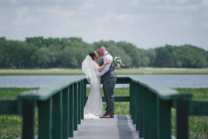 Tampa Bay Bride and Groom Outdoor Lakefront Deck Wedding Portrait | Florida Rustic Wedding Venue Lakeside Ranch