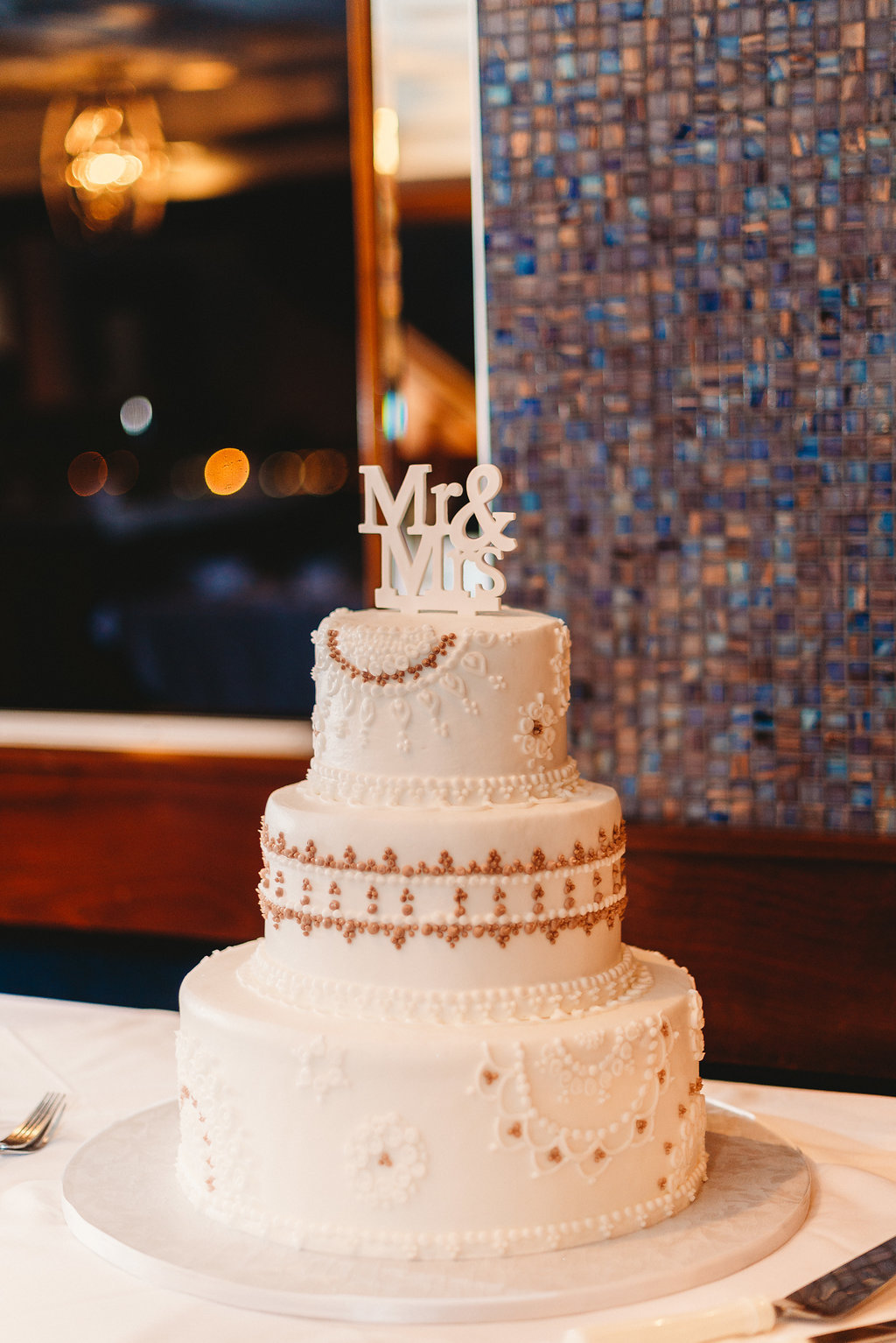 Three Tier White Cake with Floral and Whimsical Patterns and Mauve, Brown Accents with Mr and Mrs Cake Topper | Tampa Bay Wedding Cake Baker Alessi Bakeries