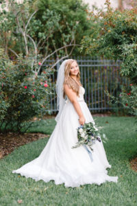 Florida Bride Outdoor Wedding Portrait, Bride in Strapless Sweetheart Lace Bodice, Tulle and Organza Ball Gown Skirt with Rhinestone Belt and Wild Organic White, Blue, Silver Dollar Eucalyptus Floral Bouquet