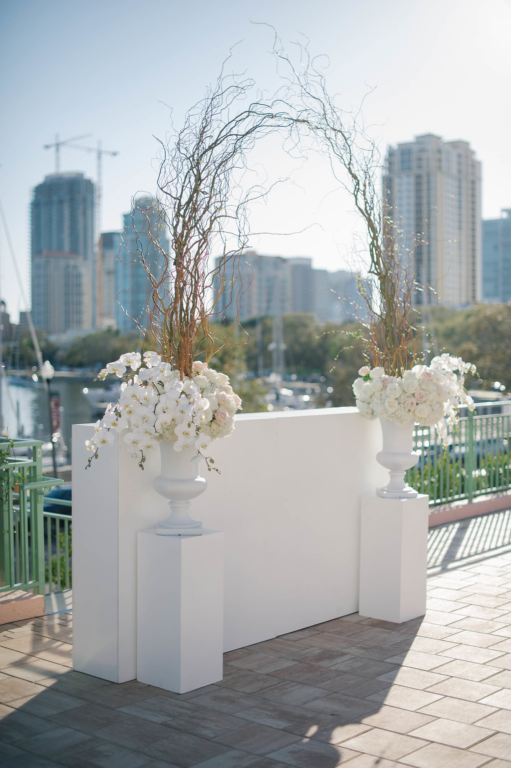 Elegant, Outdoor Waterfront Wedding Ceremony decor with white urns and manzanita branches