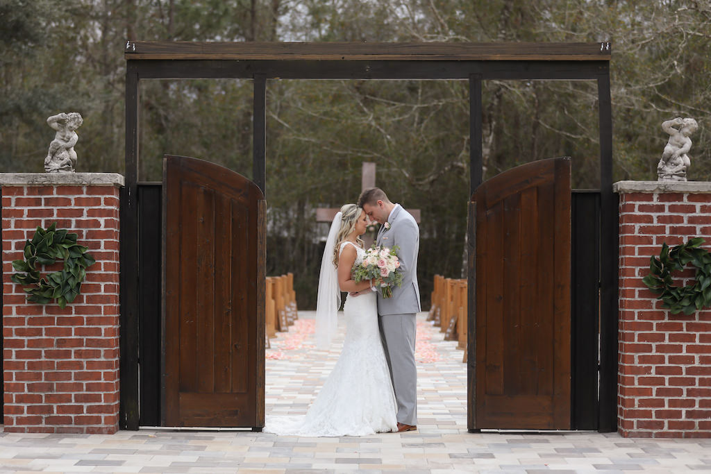 Florida Bride and Groom Wedding Portrait at Wedding Ceremony Gates Entrance | Tampa Bay Wedding Photographer Lifelong Photography Studios | Florida Rustic Wedding Venue The White Barn