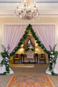 Blush Pink Drapery, Greenery Garland with Ivory Florals Curtain Entrance for Wedding Reception | Tampa Bay Linens Rental Company Over the Top Linens