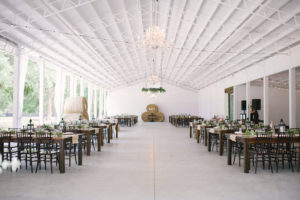 Florida Rustic Wedding Reception Decor, Long Wooden Tables with Black Chiavari Chairs, Hay Barrels, Hanging Bistro Lights | Tampa Bay Wedding Venue Lakeside Ranch
