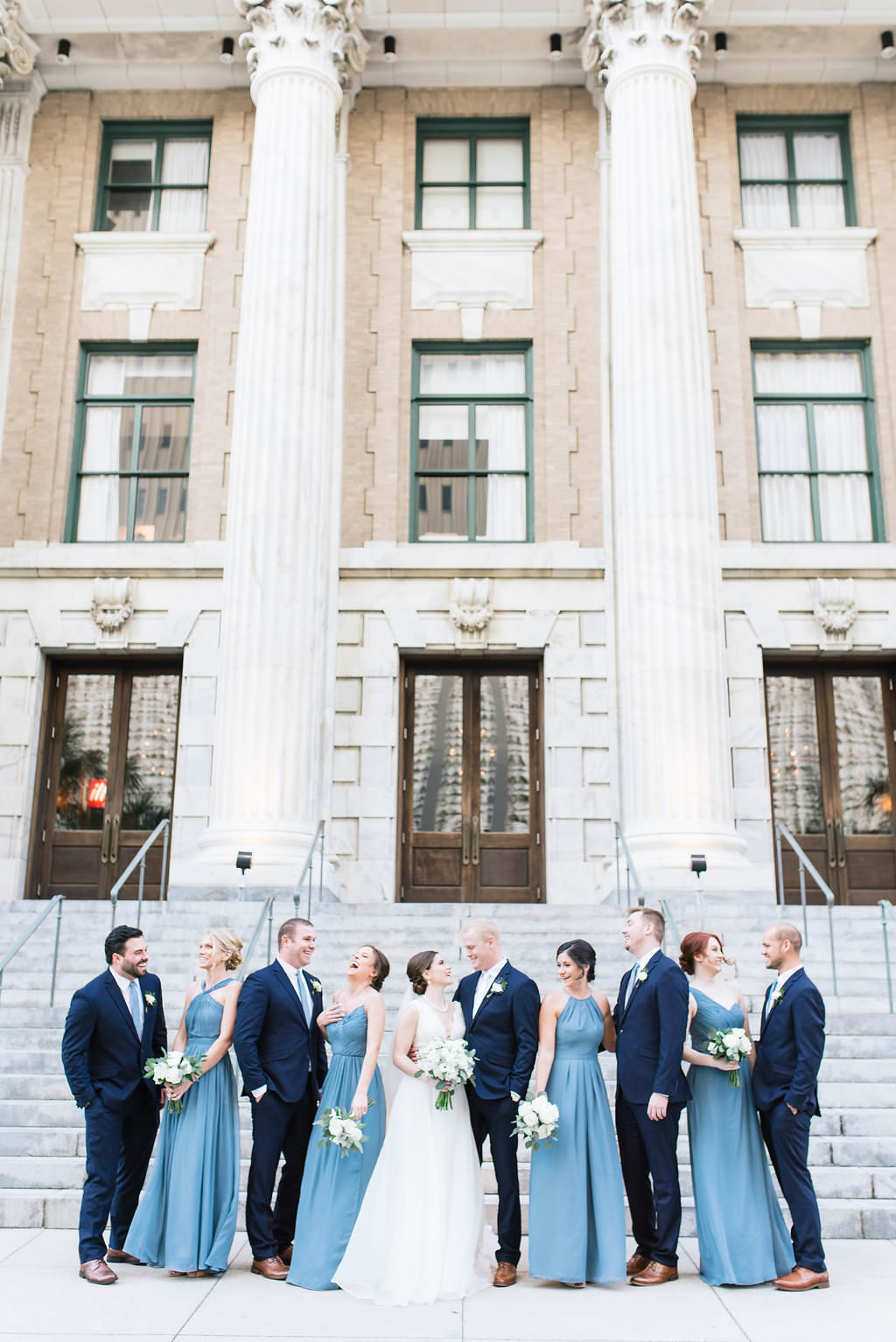 Outdoor Bride, Groom and Bridal Party Wedding Portrait on Front Steps of Historic Courthouse | Downtown Tampa Hotel Venue Le Meridien